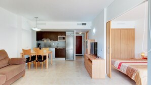 Eine moderne Wohnung mit Küche, Essbereich und Schlafzimmer.