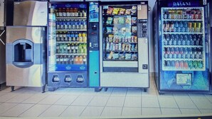 A row of vending machines in a commercial setting.