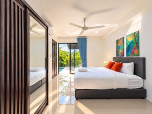A modern bedroom with a bed, a ceiling fan, and a view of a swimming pool. - Brand New Private Pool Villa Chalong Phuket Mountain View (Chalong)