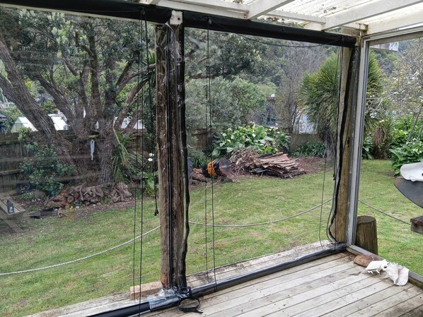 A covered patio with a view of a backyard.