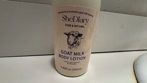 A bottle of SheDiary goat milk body lotion. - Modern 2BR Suite 202: Toledo & Sylvania Gateway (Toledo)