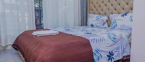 Desk, iron/ironing board, bed sheets