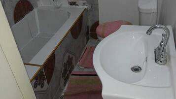Bidet, towels, soap, toilet paper