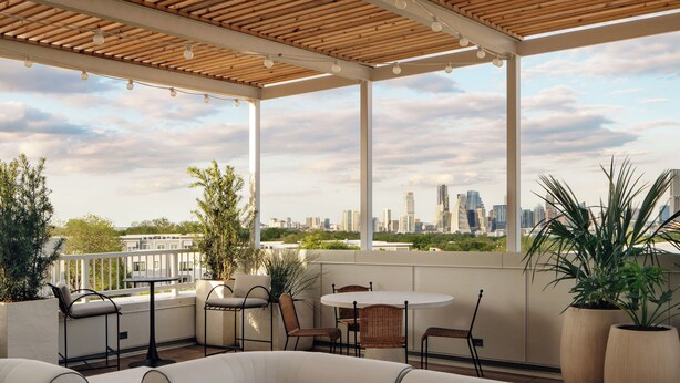A covered outdoor seating area with a city skyline view, featuring a round table, chairs, and potted plants. - South Lamar Stay w/ Private Balcony | Pool, Terrace, On-Site Dining | The Code (Austin)
