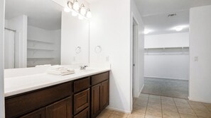 Bathroom with vanity and walk-in closet - 4BR Casa Grande Home | Game Table + Large Yard (Casa Grande)