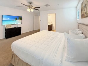 Primary bedroom with TV and bathroom access - 4BR Casa Grande Home | Game Table + Large Yard (Casa Grande)