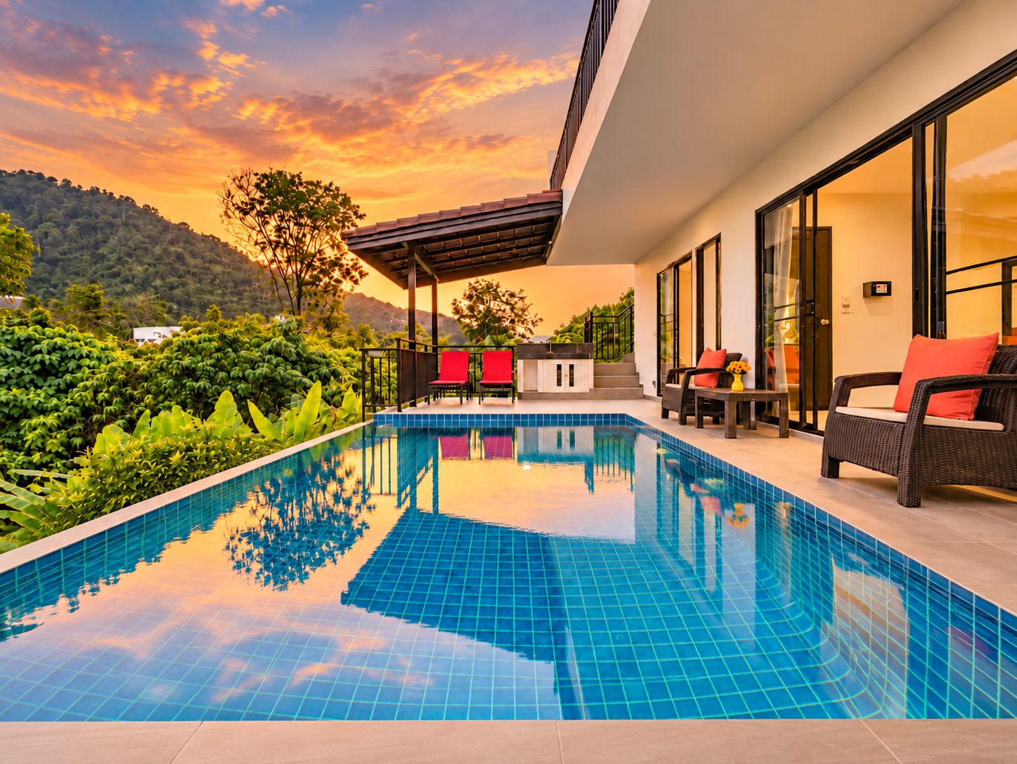 A modern outdoor pool area with a clear view of the surrounding greenery and hills.