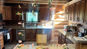 A kitchen with wooden cabinets, a granite countertop, and a 'happy birthday' sign.
