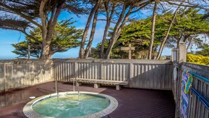 A wooden deck with a hot tub, a bench, and a wooden fence. - Monterey Dunes 144 - Moss Landing Townhome - A Mile of Beachfront! (Moss Landing)