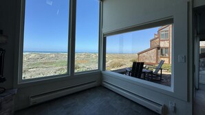 A room with large windows overlooking a coastal landscape. - Monterey Dunes 144 - Moss Landing Townhome - A Mile of Beachfront! (Moss Landing)