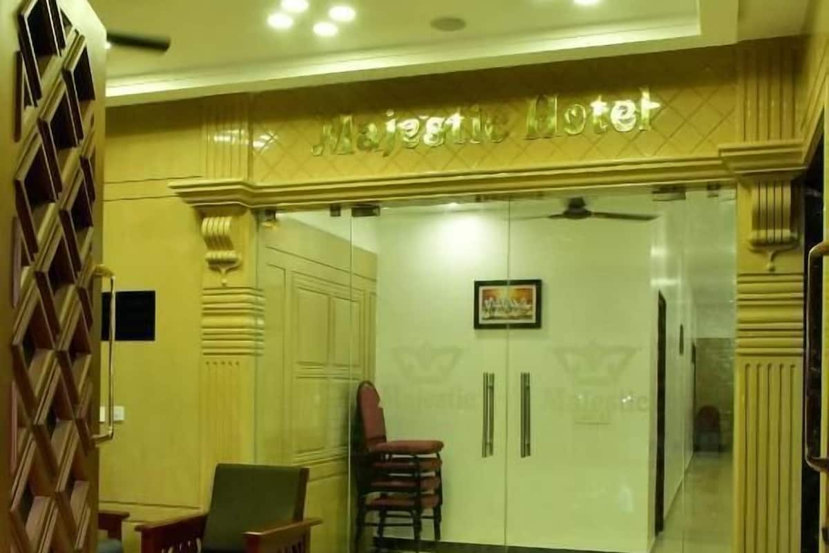 A lobby with a reception desk, seating area, and a glass partition.