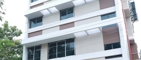 A multi-story building with a sign reading "MAJESTIC HOTEL & SERVICE APARTMENTS".