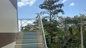 A set of outdoor stairs with metal railings, leading up to a building.