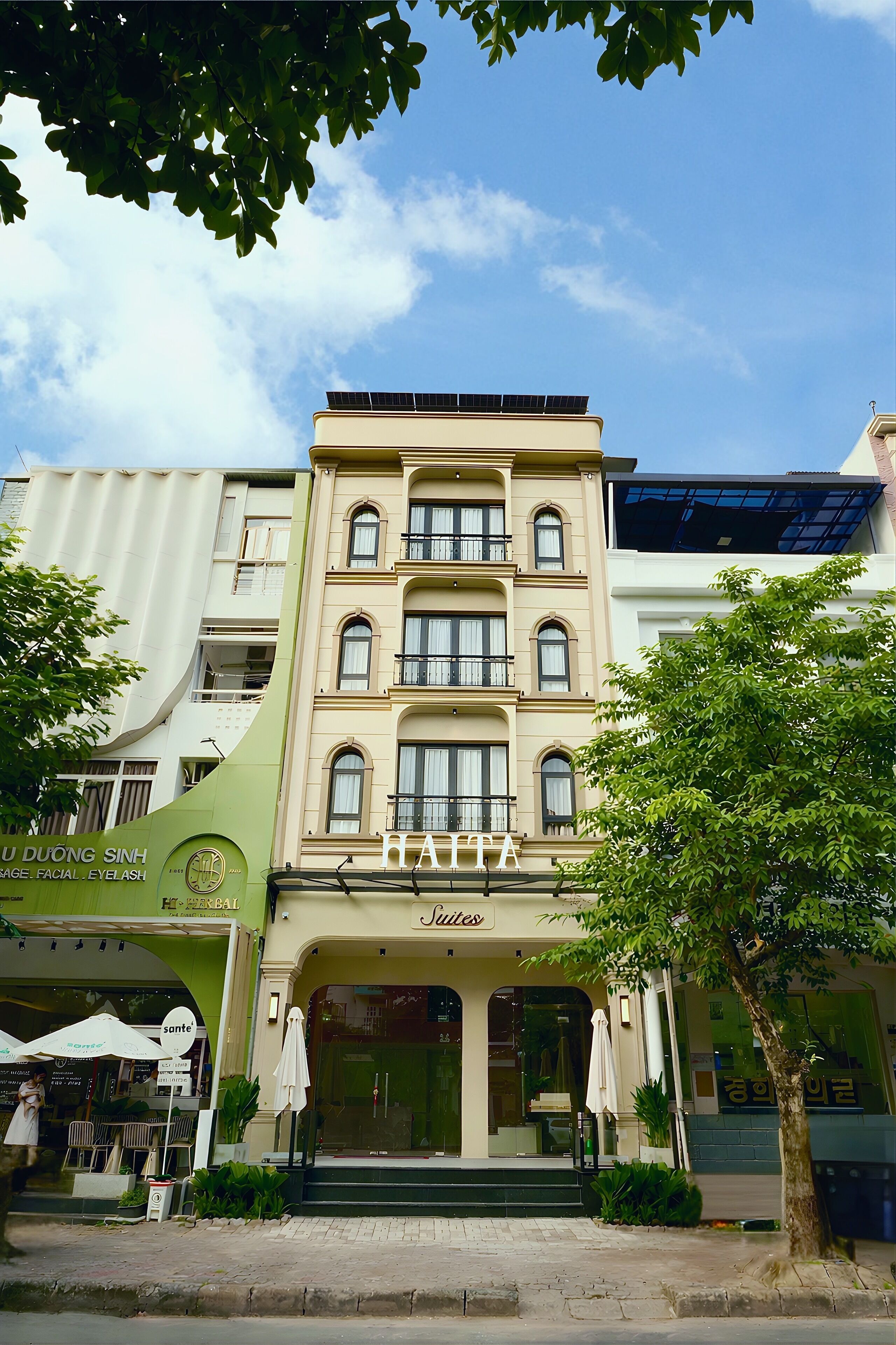 A hotel with a green awning, a sign for 'DUONG SINH', and a 'SOUTES' sign above the entrance.