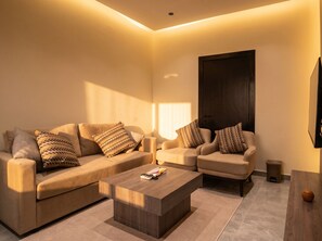 A modern living room with two sofas, a coffee table, and a TV mounted on the wall. - Vinas Riyadh Serviced Apartments (Riyadh)