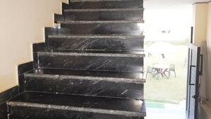 A black marble staircase leading to a second floor. - Eco Fort Resort (Mahwah)