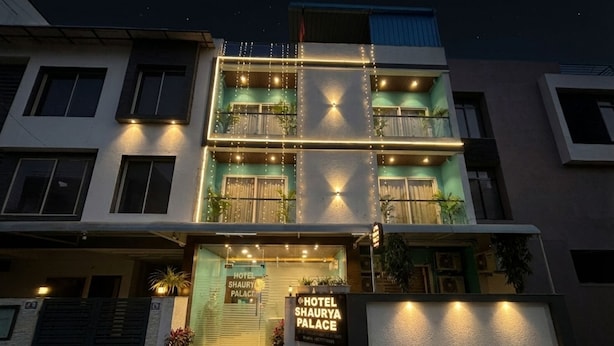 A multi-story hotel with a modern facade, illuminated windows, and a sign reading "Hotel Shaurya Palace." - Hotel Shaurya Palace (Indore)