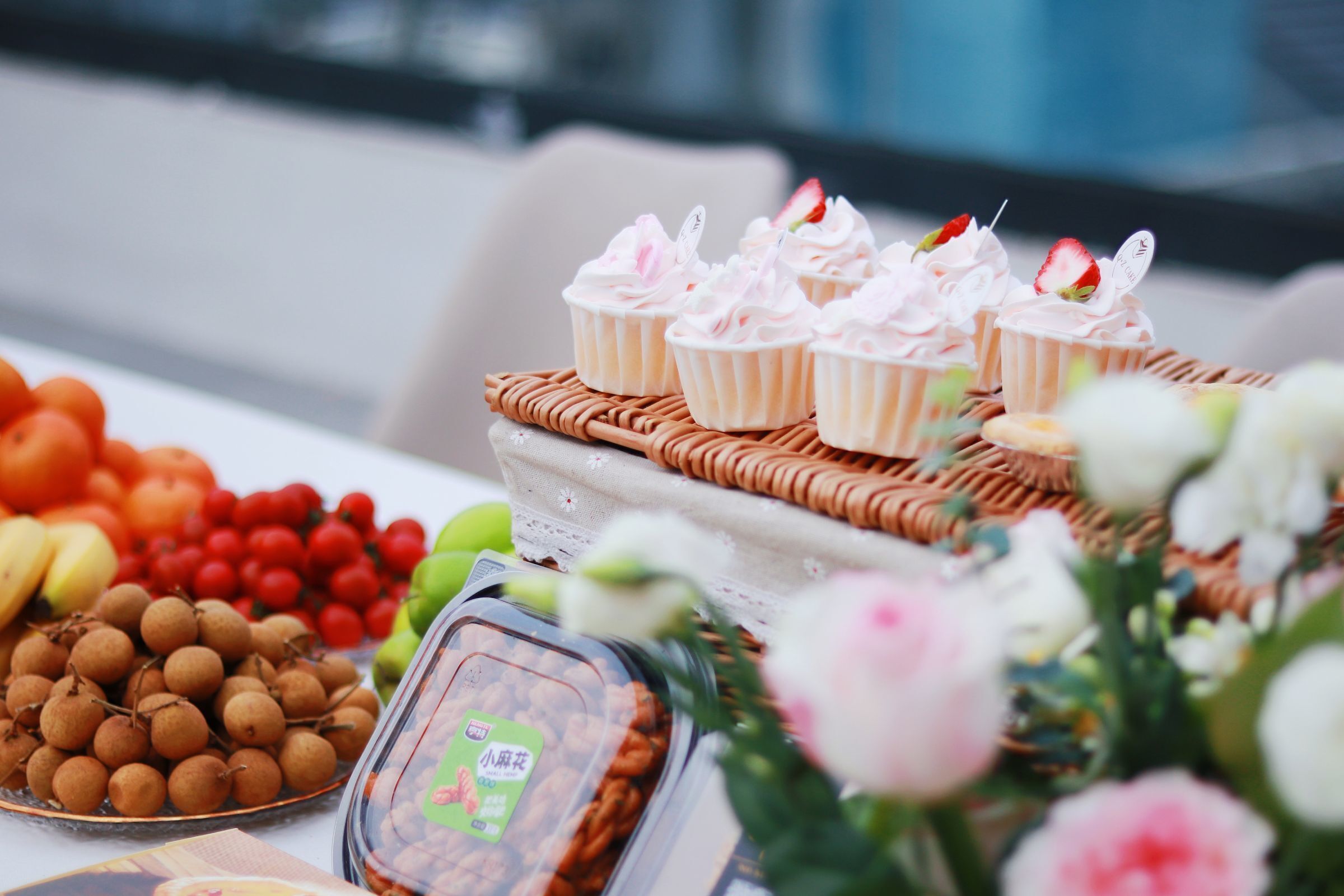 A table with food items and a wicker basket.