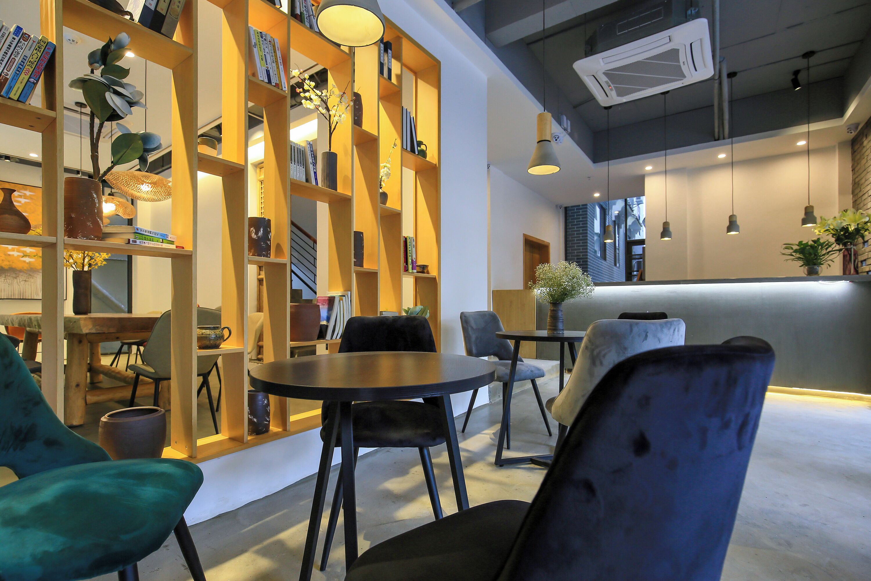 A modern interior with a bookshelf, seating area, and a counter.
