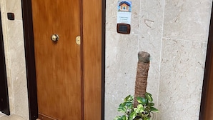 Eine Holztür mit Fußmatte, auf der 'Welcome' steht.