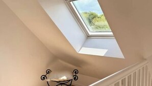 A staircase leading to a loft with a skylight. - Family home with spa bath in one of the most beautiful villages in France ! (Rochefort-en-Terre)