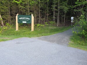 A sign for Horace Hill Recreation Area with a gravel path leading through a wooded area. - Valley Trail Riverfront Townhouse with EV Charging 2 miles from Mount Snow (Dover)