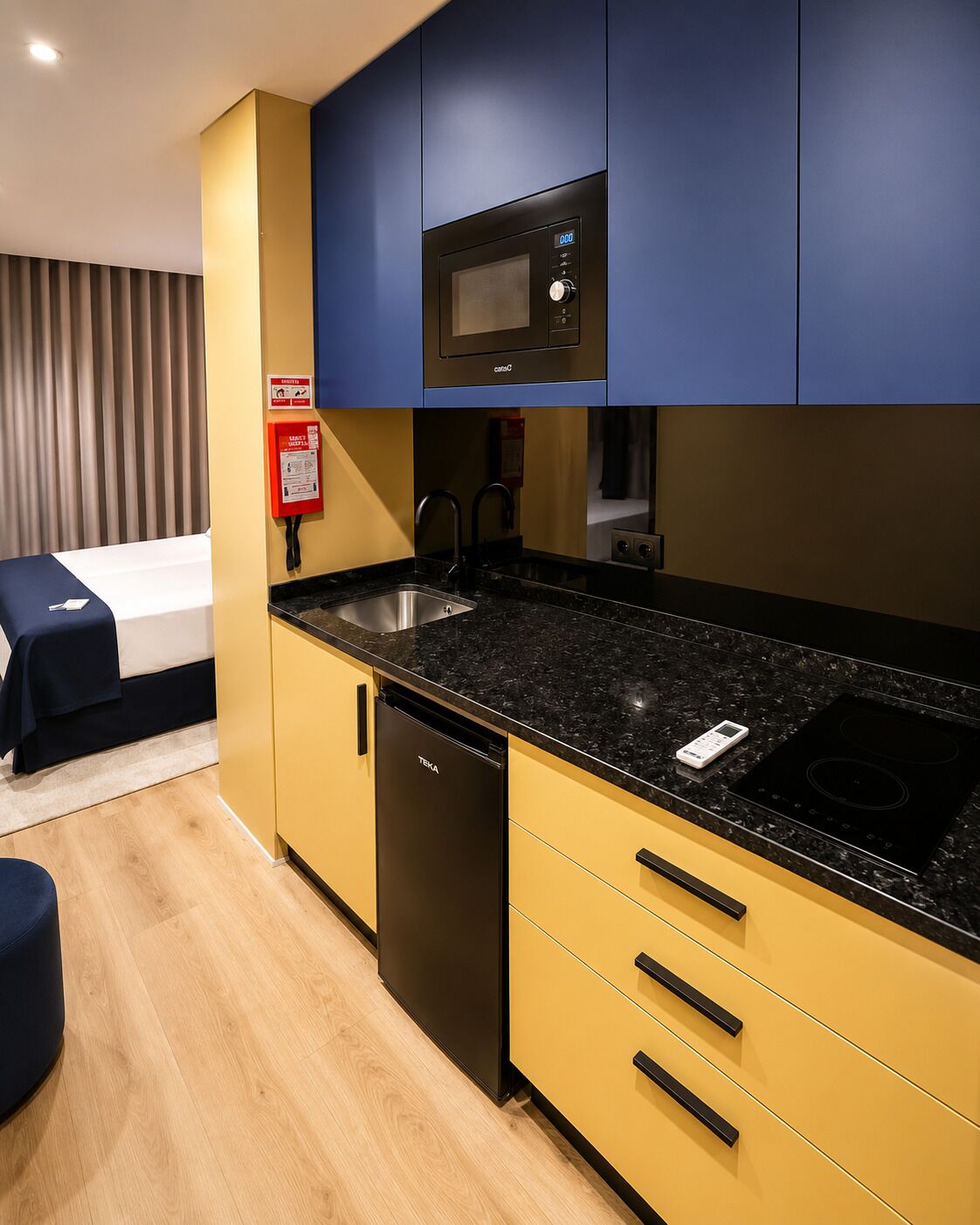 A compact kitchen with a microwave, sink, and dishwasher.