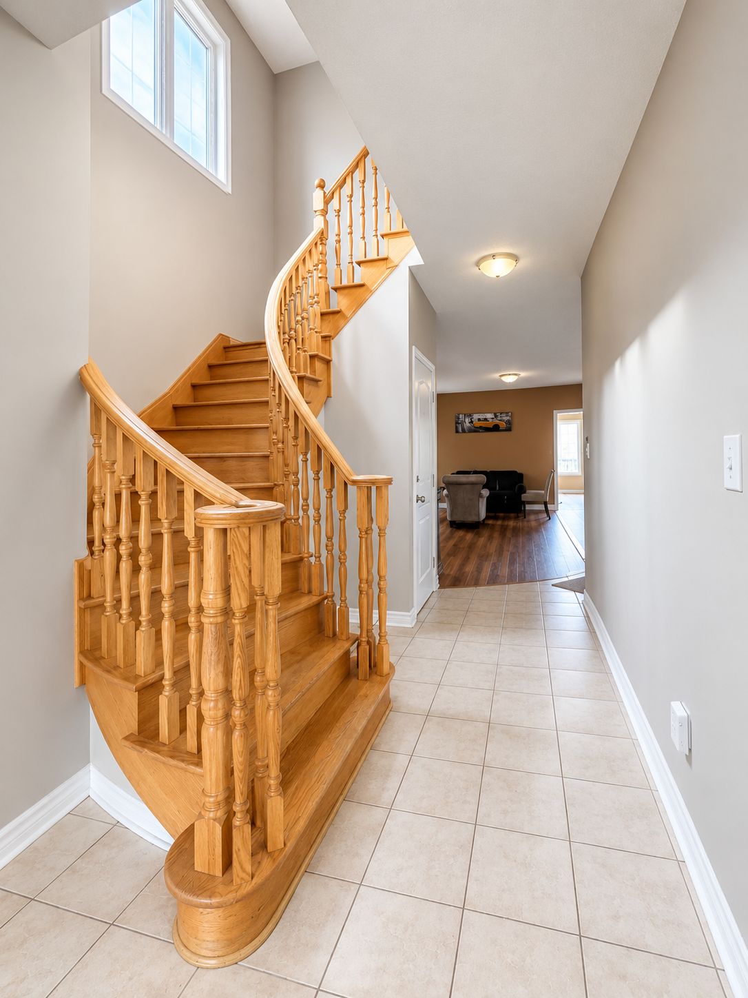 A wooden staircase with a curved design leading to a landing.