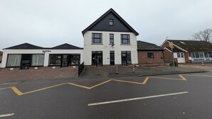 A two-story building with a white facade and a dark roof. - digby house flat 1 (West Mersea)