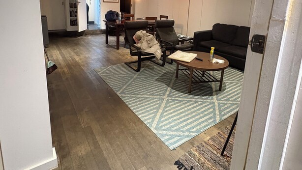 A modern living room with a sofa, armchairs, and a coffee table.