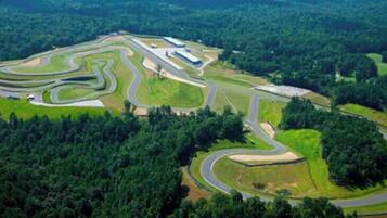 Luchtbeeld van een racecircuit, omgeven door dicht bos.
