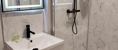 Shower, hair dryer, towels, soap