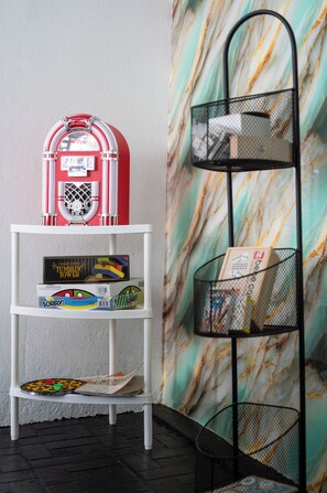 A white shelf with a red Coca-Cola vending machine and a Tumbilin Tower game box. - Modern 3BR House  A/C Parking Carolina (Carolina)