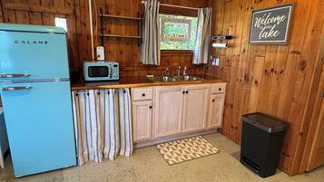 Fridge, microwave, coffee/tea maker, cookware/dishes/utensils