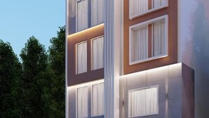 A modern multi-story building with large windows and a flat roof. - Hotel Shree Sanwaliya (Ujjain)