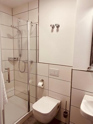 Shower, hair dryer, towels, toilet paper