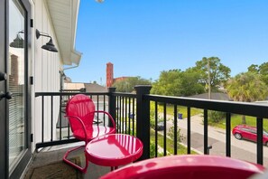 Private balcony off the primary bedroom offers a view of the historic Alvarez Cigar Factory - Cherry St Chateau | Immaculate Home In Old West Tampa, 5 Min to Ray J (Tampa)