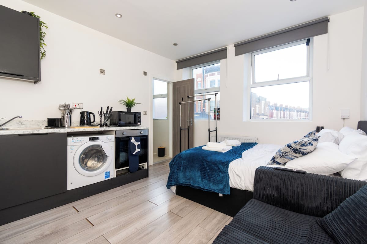 Deluxe Studio | Premium bedding, desk, laptop workspace, blackout drapes
