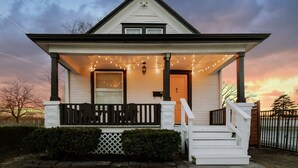 A two-story house with a porch, a staircase, and a mailbox. - Ultimate World Cup Location|Steps to Westport & KC Streetcar (Kansas City)