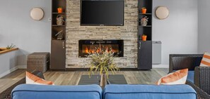 Smart TV, fireplace, books, computer monitors