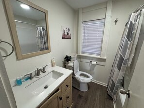 Een haardroger, handdoeken, zeep, toiletpapier