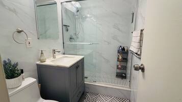 Shower, hair dryer, soap, toilet paper