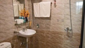 A bathroom with a sink, mirror, and towel rack. - Yuki Hanoi Center Apartment (Hanoi)