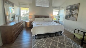 A bedroom with a bed, dresser, nightstands, and a painting. - Luxurious, Beautiful and Comfy 4-bedroom house with in the heart of San Jose (San Jose)