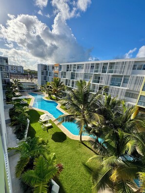 Outdoor pool, open 8:00 AM to 10:00 PM, pool umbrellas, sun loungers - Suite 403 Downtown Punta Cana (Punta Cana)