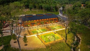 A building with a sports court, surrounded by trees and a road. - 2BR Tall Timbers Cabin | Hot Tub | Sleeps 8 | Free Tickets (Hollister)