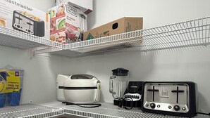 A kitchen with white shelves, a toaster, a blender, and a basket. - Slice of Heaven - Near Spruce Meadows - 2 Car Garage Central AC avail -Sleeps 8  (Calgary)