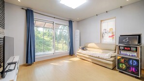 A room with a sofa, a television, a sound system, and a window with curtains. - Yangpyeong Narinsoom Private Villa (Yangpyeong)