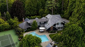 A large house with a swimming pool, tennis court, and lush greenery. - World Cup 2026 Luxury Estate, West Van,  Pool, Tennis Court, Theatre, Gym (West Vancouver)