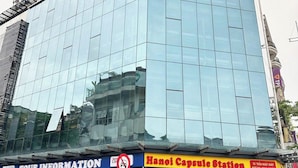A modern building with a glass facade and a sign for Hanoi Capsule Station. - HANOI CAPSULE STATION  (Hanoi)